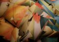 a large pile of multicolored pieces of paper