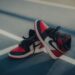 pair of black-white-and-red Air Jordan 1 shoes