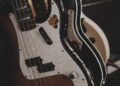 brown and black bass guitars