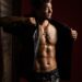 topless man in black leather jacket