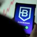 a person holding a cell phone with a blockchain logo on it