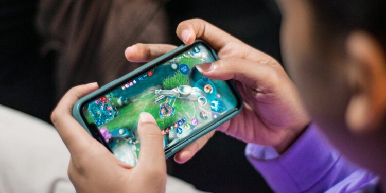 a person holding a cell phone in their hands